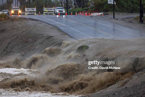 Usually dry section of the Whitewater River floods a road caused by Tropical Storm Hilary in the deserts of Southern California on August 20, 2023 in...