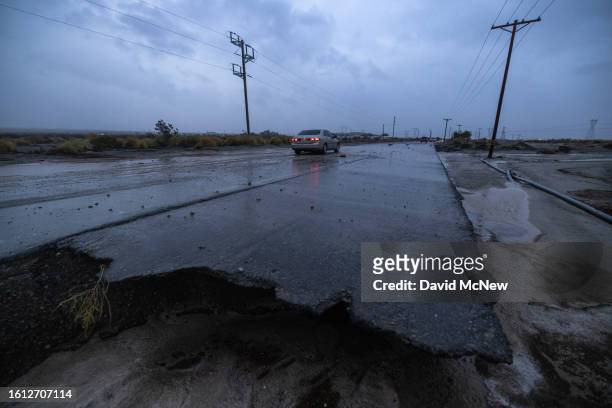 Motorist negotiates a road damaged by a flash flood from Tropical Storm Hilary in the deserts of Southern California on August 20, 2023 near Indio,...