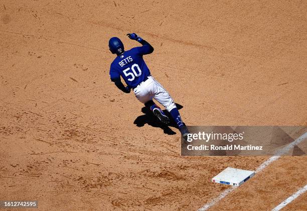 Mookie Betts of the Los Angeles Dodgers hits a two-run double against the Colorado Rockies in the sixth inning at Dodger Stadium on August 13, 2023...