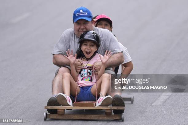Soapbox cart riders race downhill during the 10th edition of the Rolima do Abacate event during the Virada Cultural festival in Belo Horizonte, state...