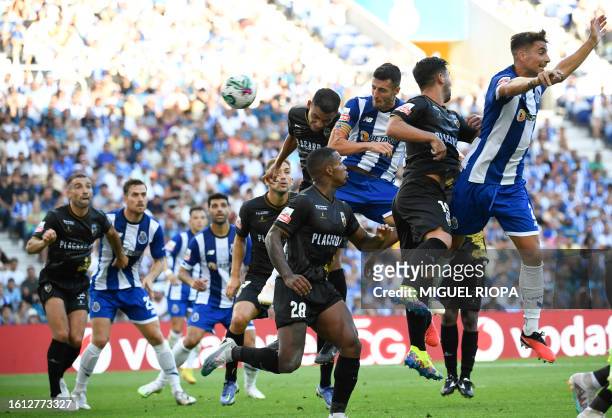 Porto's Spanish defender Ivan Marcano heads the ball during the Portuguese league football match between FC Porto and SC Farense at the Dragao...