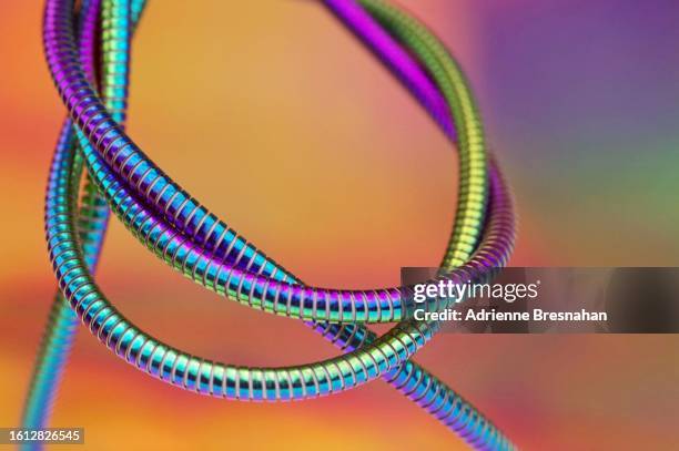 twisted and coiled metallic cable - changing colour stock pictures, royalty-free photos & images