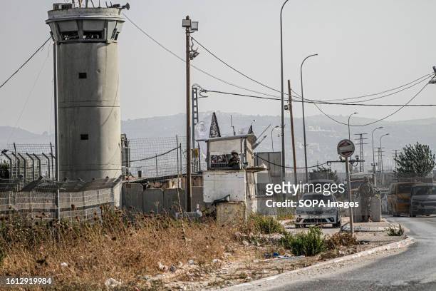 Israeli soldiers are seen guarding near a military post after closing the road during intensive operations to search for the attacker who shot at two...