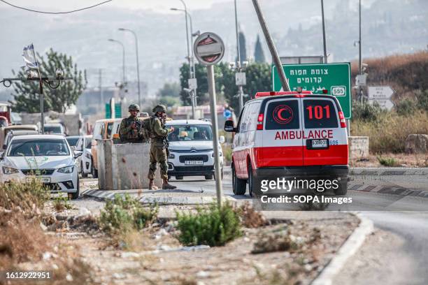 Israeli forces close the area during intensive operations to search for the attacker who shot at two Jewish settlers in the Palestinian town of...