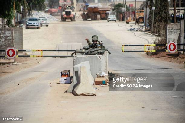 An Israeli force closes the entrance to the Palestinian village of Bita, which is located near the town of Hawara, where the shooting of two Israeli...
