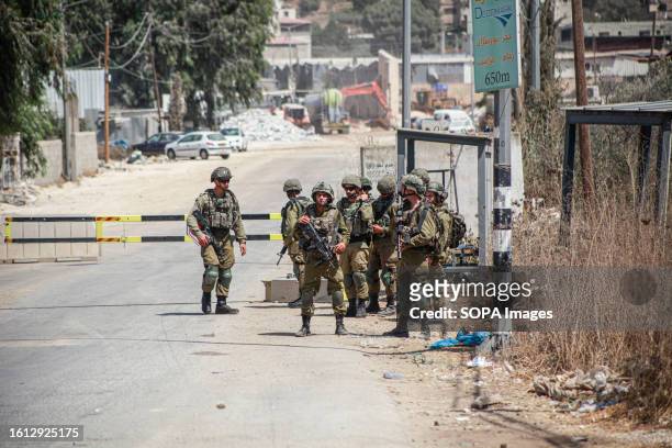 An Israeli force closes the entrance to the Palestinian village of Bita, which is located near the town of Hawara, where the shooting of two Israeli...