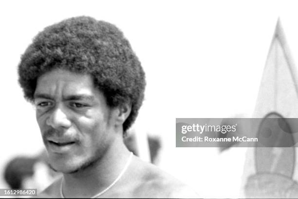 Hawaiian surfer Montgomery Ernest Thomas Kaluhiokalani, walks through the crowd on the beach at the 1981 Instinct Malibu US Pro Invitational Surf...