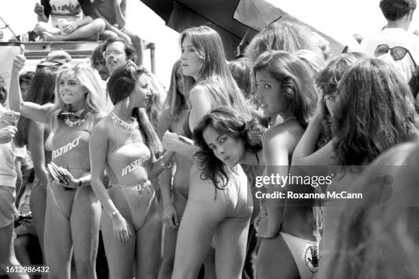 Competitors in the bikini contest at the Instinct Malibu US Pro Invitatiomal Surfing Contest line up on the beach in 1981 in Malibu, California.