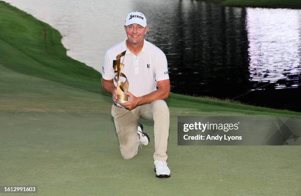 Lucas Glover of the United States poses with the trophy after putting in to win during the first playoff hole on the 18th green to win the tournament...