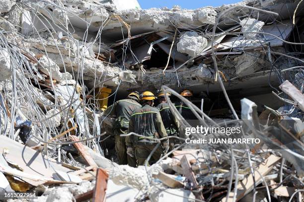 An Israeli rescue team looks for people inside a collapsed building in Port-au-Prince on January 16 four days after a 7.0-magnitude earthquake struck...
