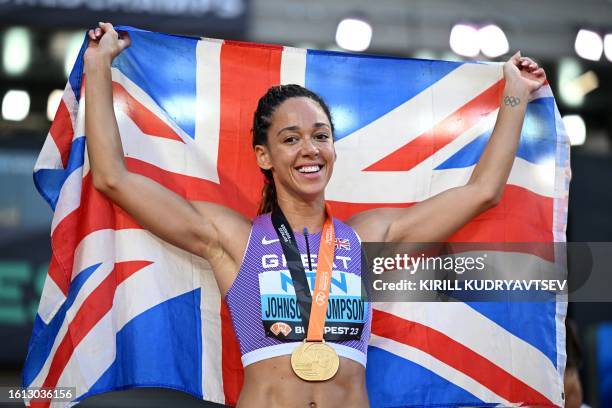 Britain's Katarina Johnson-Thompson celebrates with her gold medal after winning the overall heptathlon event after competing in the women's...