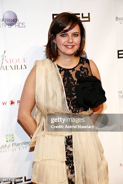 Kim Stolz poses for photos backstage at the Reality of FASHION the Reality of AIDS fall 2013 fashion show during Mercedes-Benz Fashion Week at the...