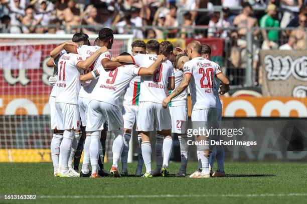 The player's of FC Augsburg form a circle prior to the Bundesliga match between FC Augsburg and Borussia Mönchengladbach at WWK-Arena on August 19,...