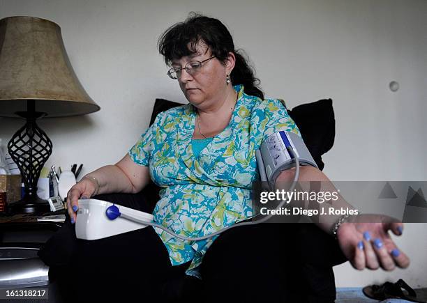 Suffering from high blood, Nathalie Cole checks her blood pressure in her Golden apartment, on Thursday afternoon, May 27, 2010. Cole participated in...