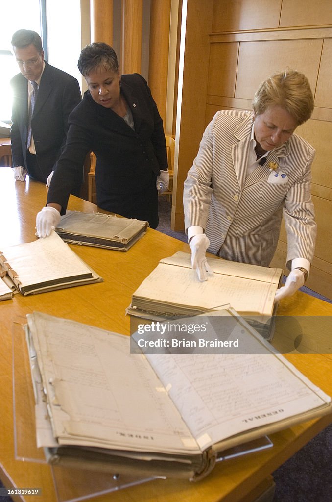 (el) cd25library_bb_3 -- An program to digitize critical city records and neighborhood history draws the attention of Dr. Anne-Imelda Radice, (right) director of the federal Institute of Museum and Library Services, who inspects the volumes. Denver Clerk