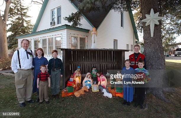 The eastern Colorado town of Wray celebrates Christmas. Gary Fore <cq> and his children pose for a photo outside the family's home in town next to...