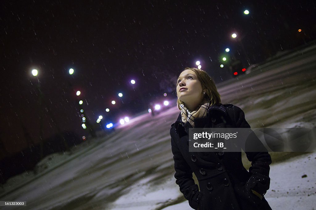 Beautiful single girl at night in the snow