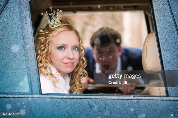 bride sitting in auto. at car looks surprised groom - winter bride stock pictures, royalty-free photos & images