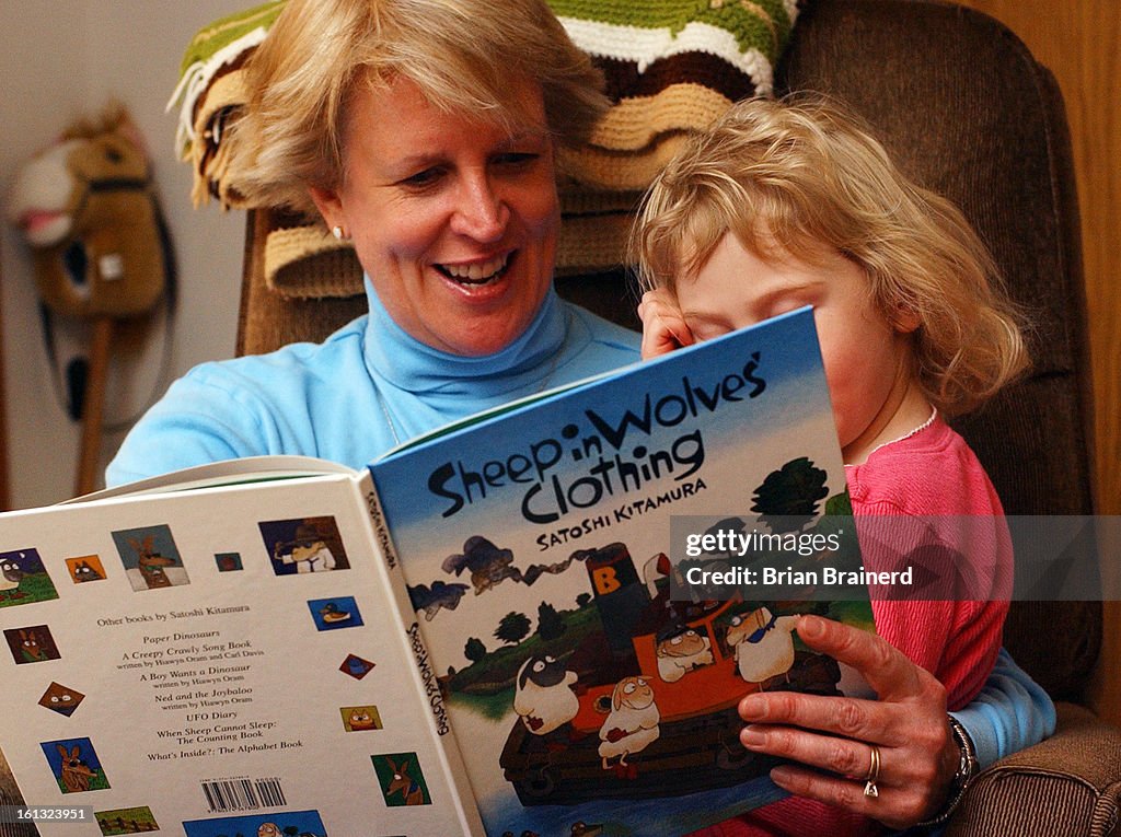 LOUISVILLE, CO, FEB 24, 2004 -- <cq> Deborah Cave <cq> reads a book to her daughter at their Louisville home. Cave is president of COCAF - Colorado Coalition of Adoptive Families. (She asked that the daughter not be identified by name or as adopted in the