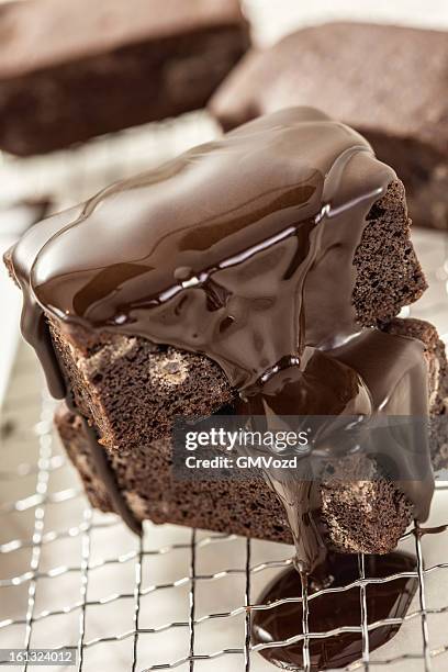 brownies with chocolate sauce - chocolate chip stock pictures, royalty-free photos & images