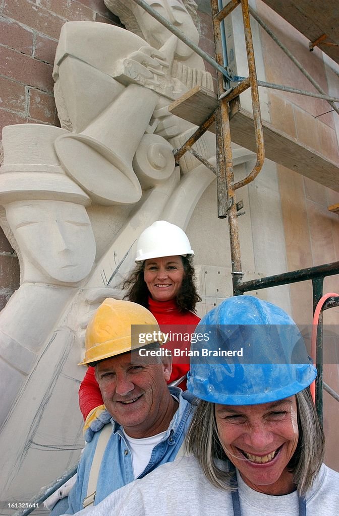 Denver, Colo. Oct. 30, 2001 -- Sculptors Madeline Wiener, front, Roger Seal and Kathleen Caricof pause while doing the finishing work on one of two 40-foot sculptures on the new Lamont School of Music building on the DU Campus. The panels are carved from 