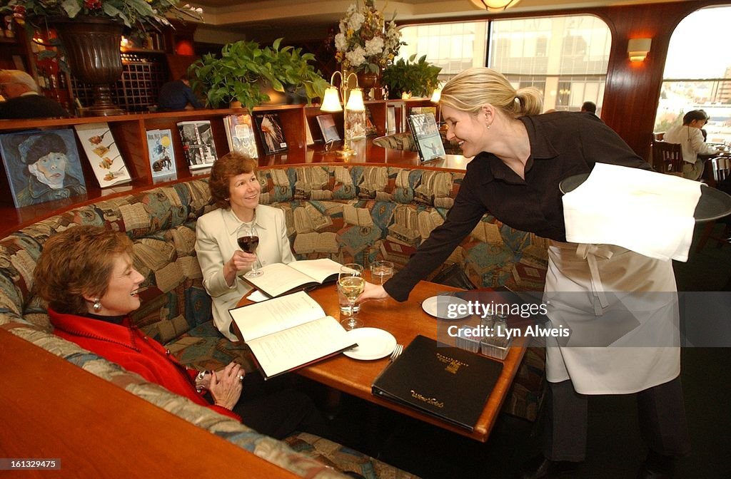 The Fourth Story Restaurant is on the 4th story of the Tattered Cover Bookstore (2955 East First Ave.). Debbie Lynch (left) and Sue Clark enjoy lunch as server Truley Check (right) brings glasses of water and wine to the table. (The Denver Post/Lyn Alweis