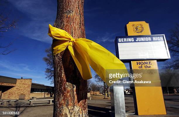 Yellow ribbons are tied around trees surrounding Gering Junior High where Heather Guerrero attended school. Her body was found in an abandoned house...