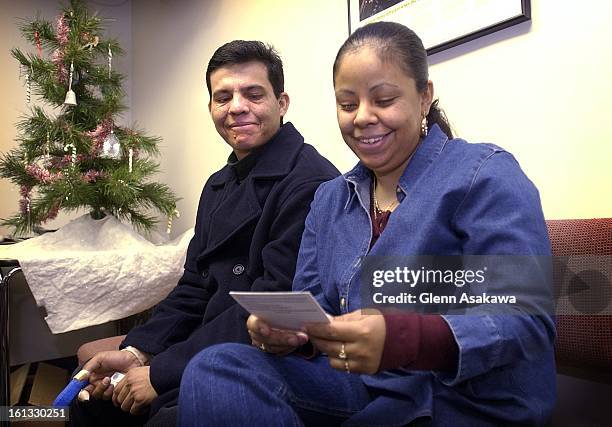 Suzanna and Pedro Hernandez, parents of Oscar, the 5-year-old leukemia patient, smile as they look over I-94 cards which allows them and their...