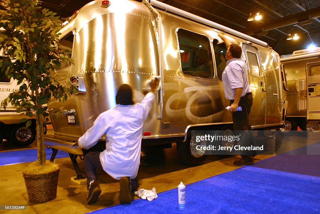 Jeffrey James, left, and Jef [cq] Fleming of Windish RV Centers, Inc. of Lakewood polish the exterior of a 22-foot Airstream CCD travel trailer in preparation for the 13th Annual Colorado RV Adventure Travel Show. The show, which runs Thursday through Sun