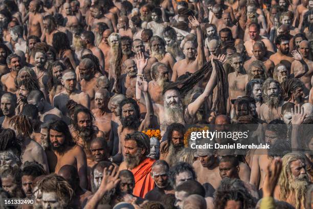 Naga Sadhus, naked Hindu holy men, walk in procession after having bathed on the banks of Sangam, the confluence of the holy rivers Ganges, Yamuna...