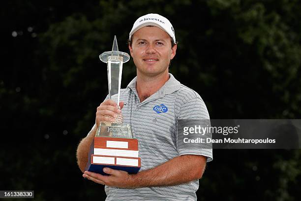 Richard Sterne of South Africa celebrates with the trophy after winning the Joburg Open at Royal Johannesburg and Kensington Golf Club on February10,...