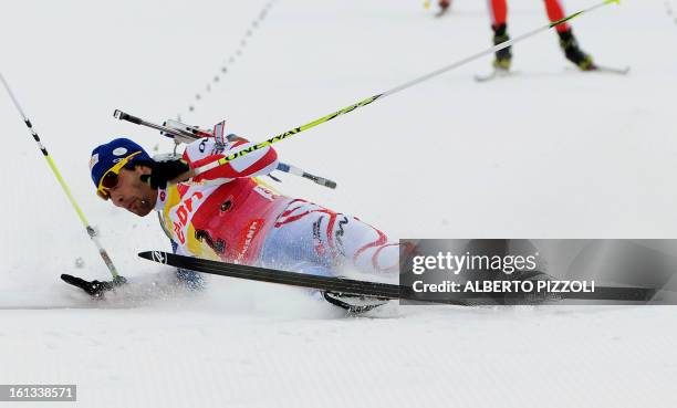 France's Martin Fourcade falls in front of the finish line during the pursuit men12,5 km as part of IBU Biathlon World Championships in Nove Mesto,...