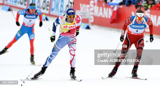 Russia's Anton Shipulin, France's Martin Fourcade and Norway's Emil Hegle Svendsen compete during the men12,5 km pursuit as part of IBU Biathlon...