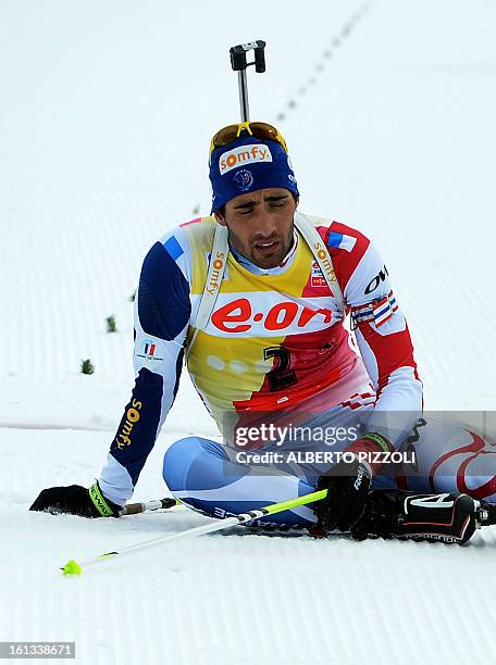 France's Martin Fourcade reacts after falling in front of the finish line during the pursuit men12,5 km as part of IBU Biathlon World Championships...