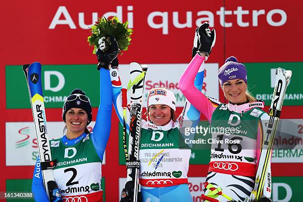 Race winner Marion Rolland of France celebrates at the flower ceremony with second placed Nadia Fanchini of Italy and third placed Maria Hoefl-Riesch...