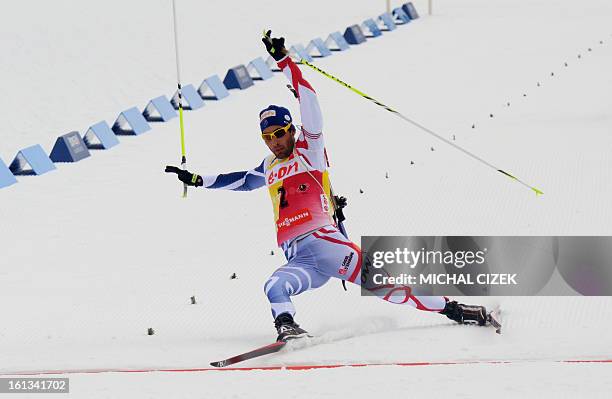 France's Martin Fourcade falls in front of the finish line during the pursuit men12,5 km as part of IBU Biathlon World Championships in Nove Mesto,...