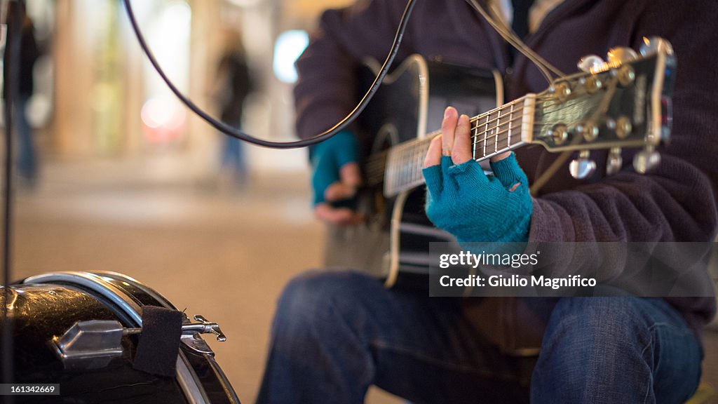 The musician with the blue gloves