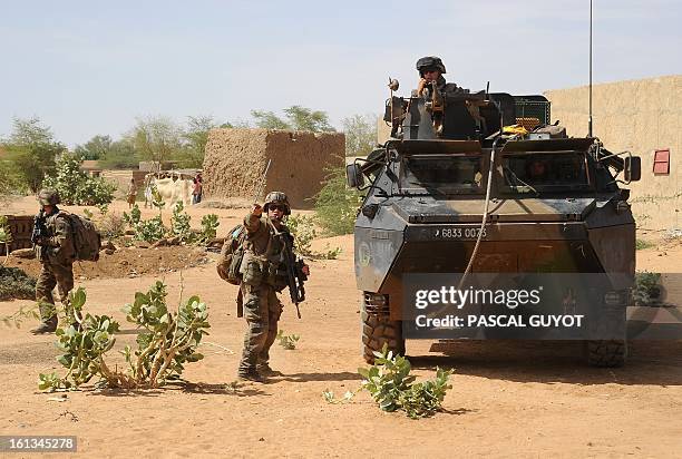 French soldiers patrol at the site where a suicide bomber blew himself up on February 10, 2013 in northern Gao on the road to Gourem.Fighting between...