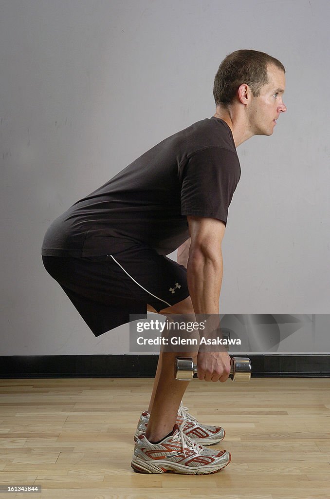 (GA) ---FE17FTWEIGHTS-- Lee Cherry, exercise physiologist with Strength from Within LLC demonstrates proper squat form keeping his knees behind his toes and his back remains straight. Glenn Asakawa / The Denver Post