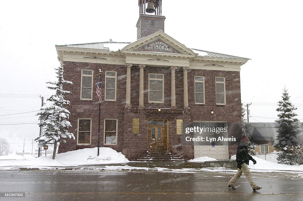 MONTROSE,COLORADO-MARCH 29, 2006- SNOW IN SILVERTON Jon Allen <cq> walks by the Silverton City Hall, built in 1908, in Silverton, Colorado, in a snowstorm. A spring storm in the southwestern part of Colorado was leaving up to two feet of snow in the San J