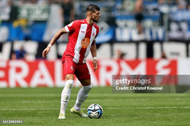 Andreas Wiegel of Essen runs with the ball during the DFB cup first round match between Rot-Weiss Essen and Hamburger SV at Stadion an der...