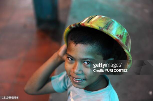 Little refugee boy gets ready to take a shower at a temporary shelter set at Polideportivo sport complex in San Vicente, some 80 Km east of San...