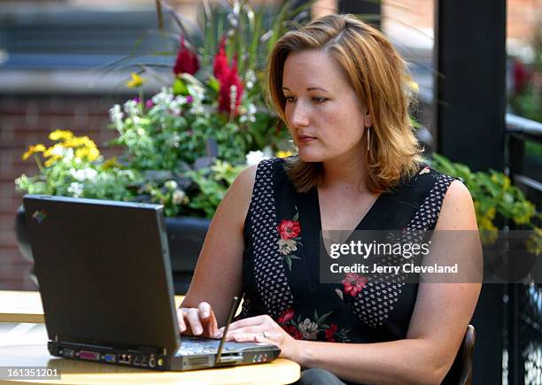 August 14, 2003 - Stefanie Jones <cq> of Denver uses her IBM laptop computer and Ricochet <cq> wireless modem to check her email while sitting in the...