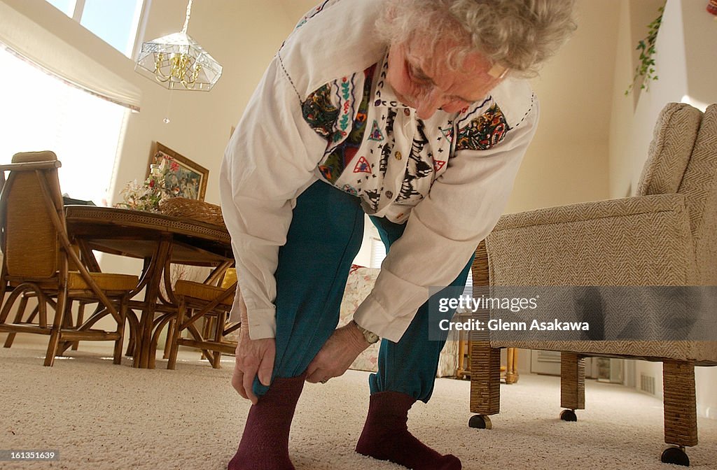 FORT COLLINS, CO, SEPTEMBER 31, 2003 - Shirley <cq> Young <cq> , 81, of Fort Collins, dons a hat, long sleeved shirt and stuff her pant legs inside her socks to protect herself from mosquitos before watering her flowers and shrubs around her townhome. "At