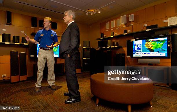 Best Buy employee Colton Davis<cq>, left, points out features of various speakers to Stew Larsen<cq> of Castle Rock in the speaker room of the new...