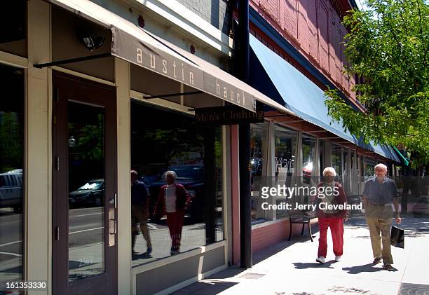 Shoppers walk by the Austin/Hauck Men's Clothing<cq> store on West Main St. In historic downtown Littleton, Colo. Wednesday morning, 6/22/2005. The...