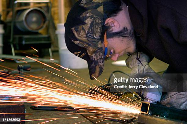 January 23, 2007 - Brandon Dixon <cq> grinds a weld on new equipment for a snowcat at Eclipse Snow Park <cq> at St. Mary's Glacier in Clear Creek...