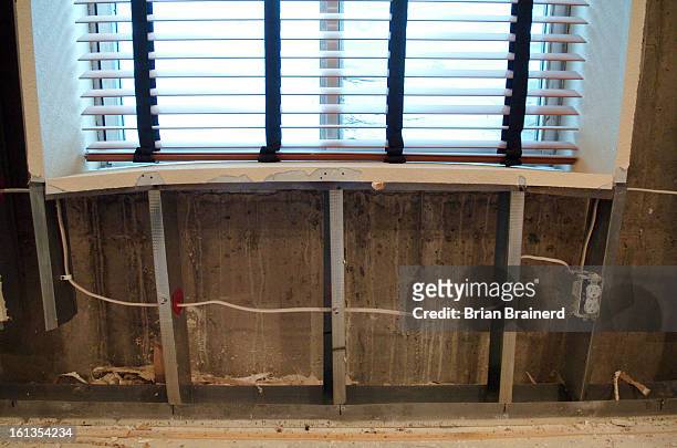 The bowed window sill in the home of Travis Fonseca, where a heaving floor slab broke drywall and damaged the interior stairwell in the basement of...