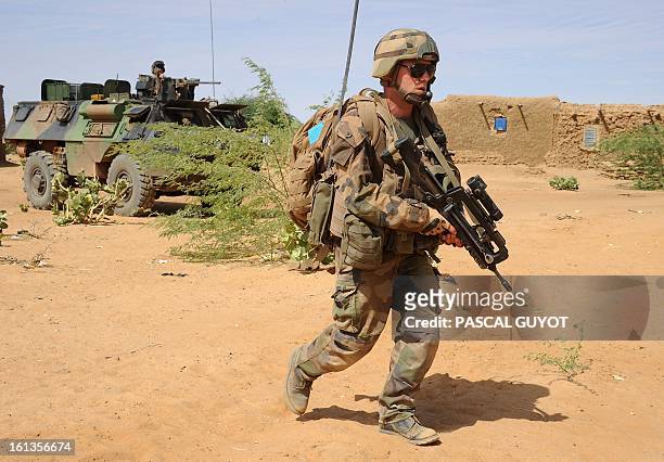 French soldiers patrol at the site where the suicide bomber blew himself up on February 10, 2013 in northern Gao on the road to Gourem. Fighting...