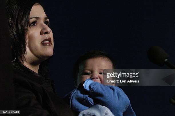 Christina Reyes talks about her husband, Sgt. Luis Ricardo Reyes, who died in a bus accident in Kuwait, Nov. 18. She is holding their son, Nikko, who...